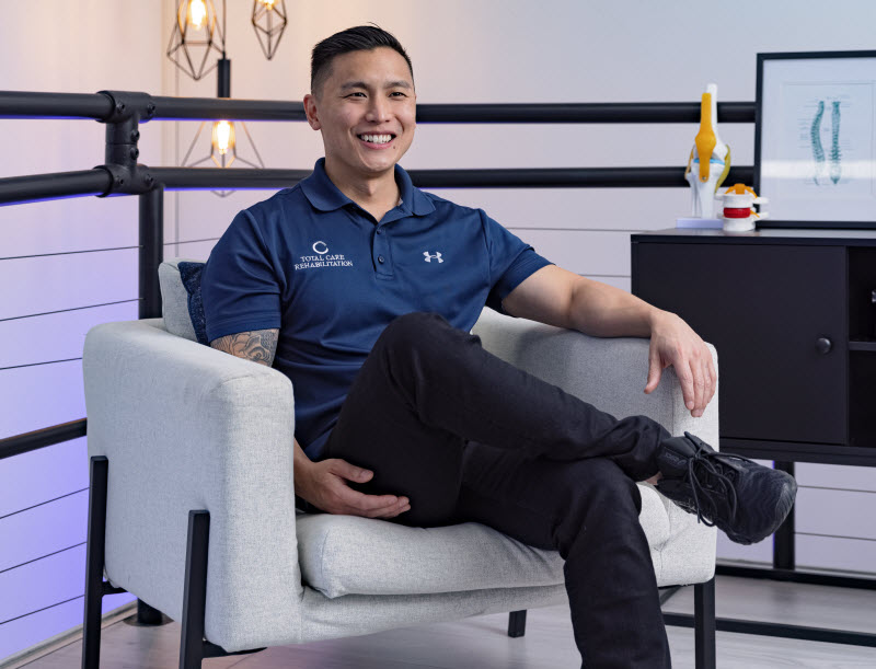 Man smiling while sitting on a couch