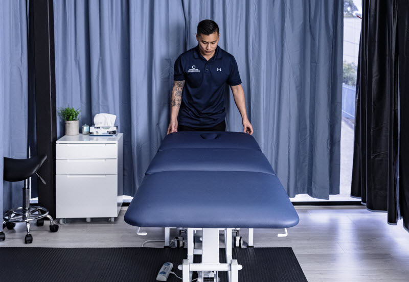 Man fixing the massage bed